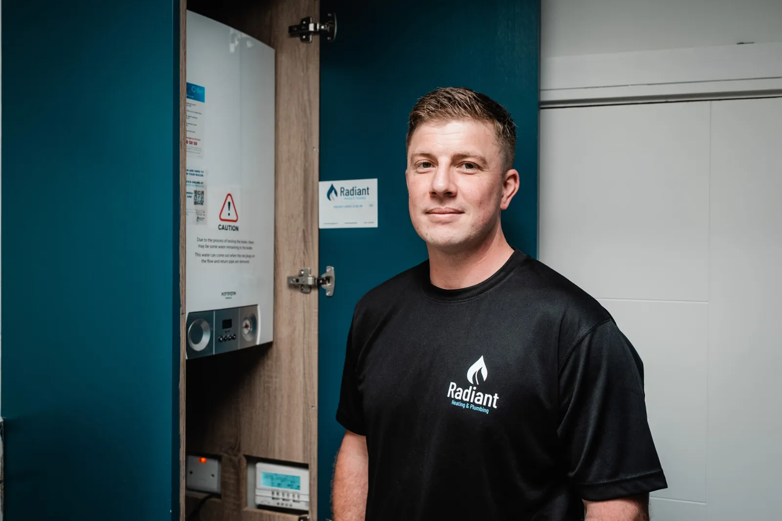 Gerard beside a freshly serviced gas boiler in a customer's home