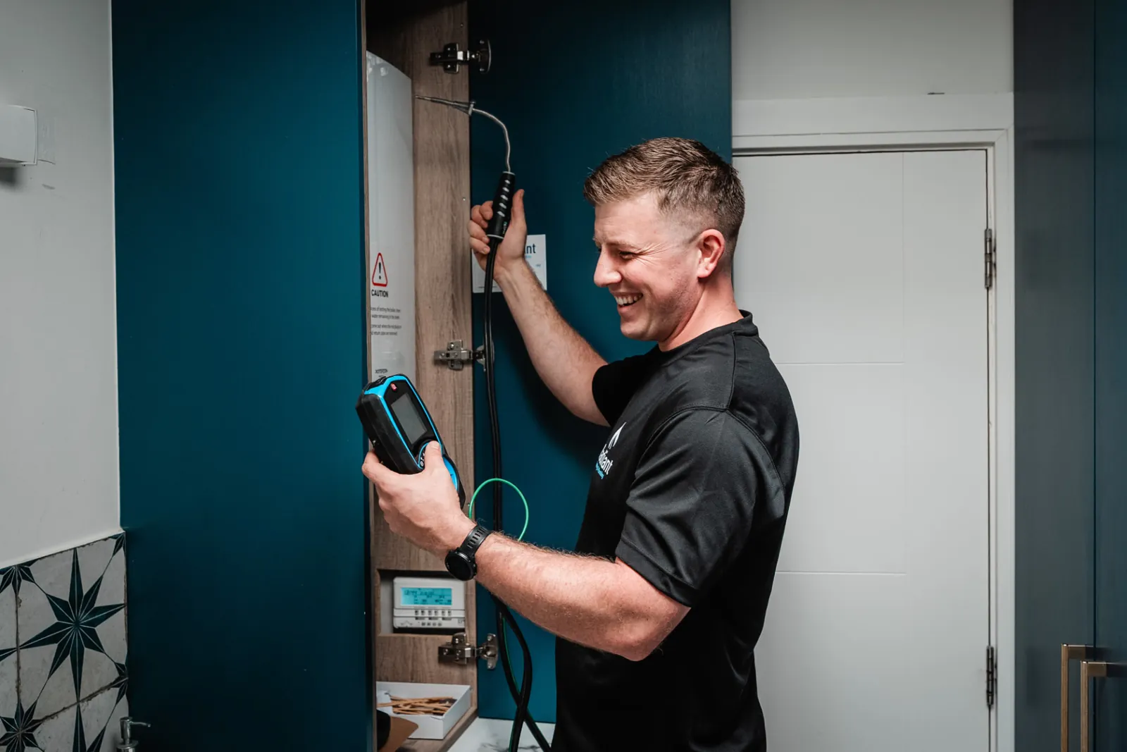 RGI registered engineer using a Kane analyser during a boiler service